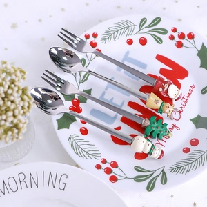 Christmas 304 stainless steel cutlery set with Santa and reindeer handles on festive plate