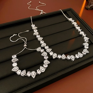 Macro view of silver adjustable teardrop zircon necklace and bracelet jewelry set