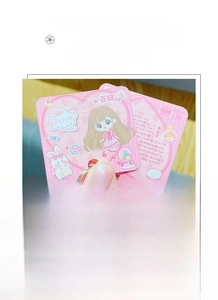 Close-up of pink cartoon girl and bunny decorative card for keychain accessories