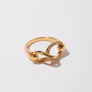 Detail of interlocking golden ring band featuring fine micro-pave cubic zirconia settings