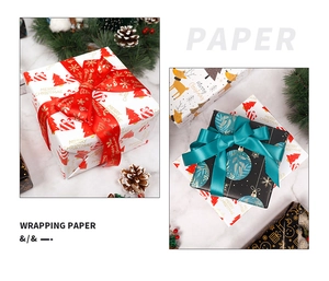 Christmas wrapping paper with red reindeer and gold tree prints, tied with satin ribbons