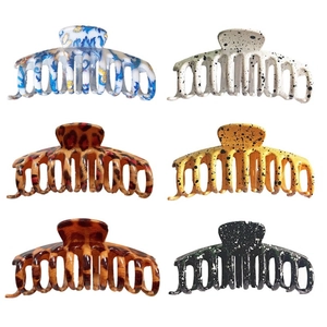Detail showcasing six large plastic hair claws in diverse prints like leopard and marble