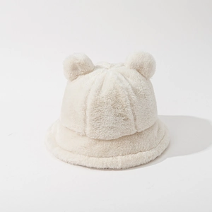 Close-up of plush bear ear bucket hat in beige faux fur showing soft winter texture