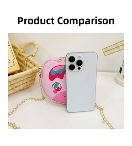 Pink cartoon girls crossbody bag detail with golden chain strap next to a phone for size