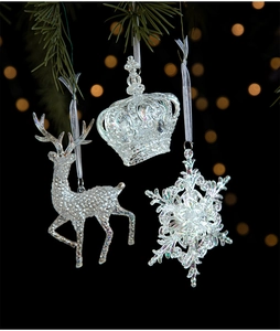 Detailed view of iridescent acrylic Christmas pendants with reindeer, crown, and snowflake