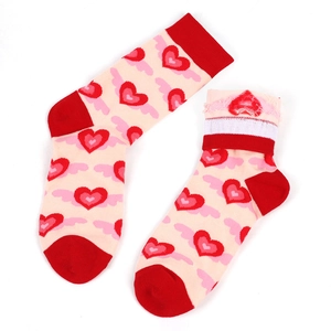 Detailed view of pink cotton crew socks with red hearts and wing patterns