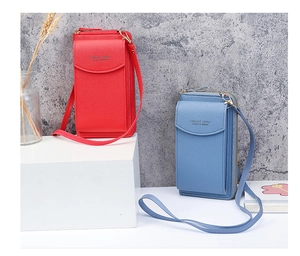Detail of long crossbody phone wallets in red and light blue with golden lettering