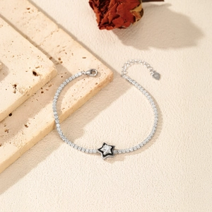 Sparkling S925 sterling silver tennis bracelet with star pendant on elegant stone surface