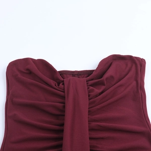 Detail of burgundy ruched bodycon dress showing intricate pleats and stitching