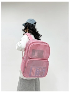 Rear view of pink breathable mesh backpack with multiple storage compartments on model