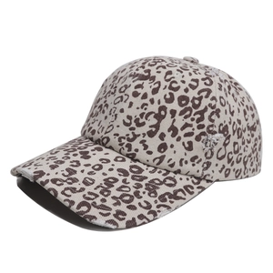 Close-up of leopard print baseball cap with distressed brim and vintage torn fabric detail