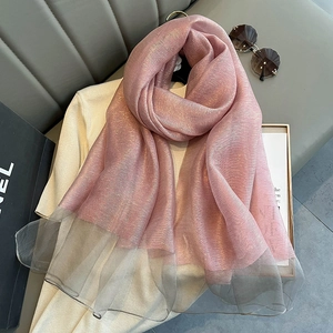 Detail of pink silk scarf with glitter effect and gray mesh trim on a fashion setting
