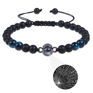 Detail of beaded projection bracelet showing 100 languages I love you stone and matte beads