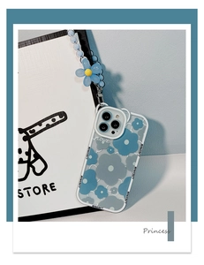 Detail view of blue frangipani iPhone case with matching floral beaded charm lanyard