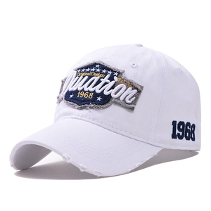 Distressed white cotton baseball cap with vintage 1968 Duration embroidery and wide brim