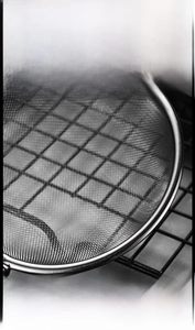 Macro detail of ultra-fine stainless steel mesh and reinforced edge of the mini strainer