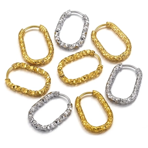 Macro shot of rectangular stainless steel hoop earrings with diamond-cut texture in gold and silver