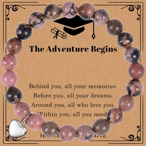 Macro shot of natural agate stone beads bracelet with a silver heart pendant on gift card