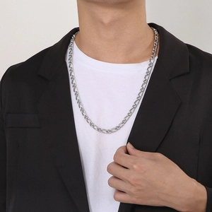 Silver retro twisted curb chain necklace styled on male model with black suit and white tee