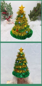 Detail view of festive green tinsel Christmas tree hat with colorful pom-poms and gold star