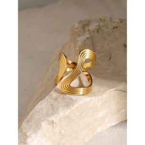 Minimalist 18k gold plated stainless steel wavy open ring on a natural stone base