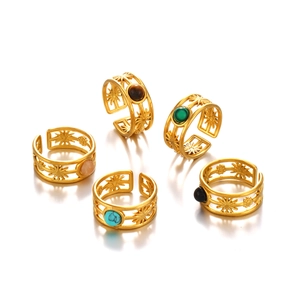 Set of five gold open rings with sunburst patterns and colorful gemstone inlays
