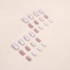 Short pink glitter press-on nails set with matte and shimmer finish on beige background