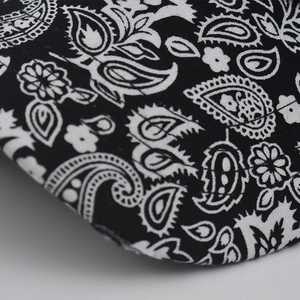 Detailed macro view of black and white paisley pattern with precise double stitching