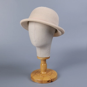 Vintage beige knitted cloche hat with a curved brim and decorative ribbon detail