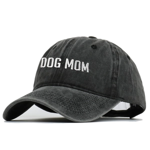 Close-up of DOG MOM white embroidery on charcoal gray washed cotton baseball cap
