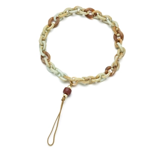 Detail of tortoiseshell acrylic chain phone strap with gold ring and red bead