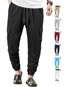 Detail of cargo pants showing drawstring waist, side pockets and vertical fabric texture