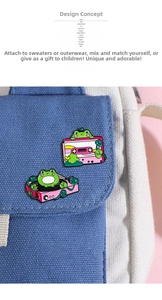 Detail of pink cartoon frog enamel pins with music tape and record player on blue canvas bag