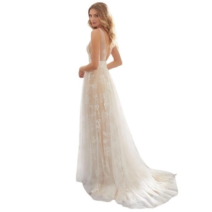 Detail of elegant backless lace wedding dress with deep V-back and long trailing skirt
