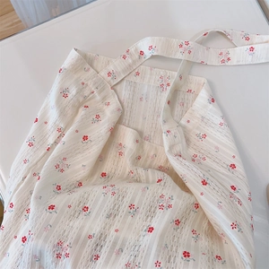 Detailed texture of cotton lace tote bag with delicate red floral patterns