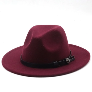 Close-up of wine red fedora hat with black leather band and silver floral buckle detail
