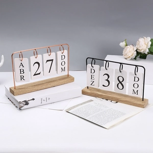 Nordic wooden flip calendar with metal frame and white roses on minimalist desk