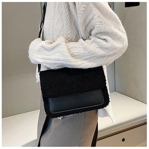 Detail of black faux fur and leather patchwork on women's winter crossbody bag