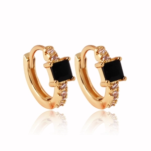 Close-up of gold-plated hoop earrings with square black gemstone and clear zircon accents