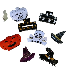 Halloween claw clip set featuring pumpkin, skull, and wizard hat designs in acetate