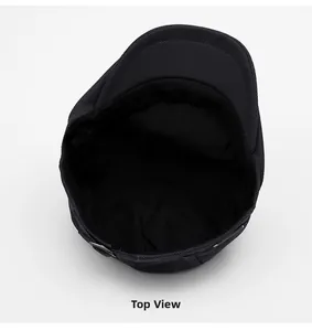 Top view of dark grey flat cap showing textured fabric and interior lining details