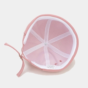 Detail view of pink docker cap interior featuring cotton fabric and metal buckle