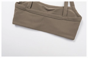 Detailed macro view of the brown ribbed fabric and high-quality stitching on sports bra