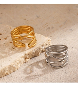 Detail view of 18K gold and silver layered open rings on a textured stone base