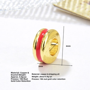 Detail view of 6mm 18k gold plated copper spacer bead with red enamel for DIY jewelry