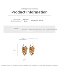 Detailed view of gold grape-shaped alloy earrings with frosted texture and silver pins