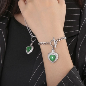 Parure collier et bracelet en acier argenté avec pierres œil de chat vertes