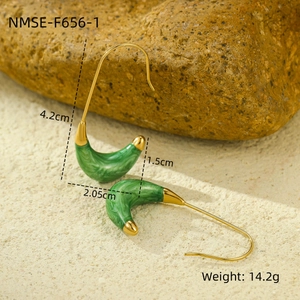 Detail of C-shaped stainless steel earrings with emerald green marble inlay and 18K gold finish
