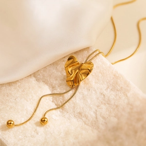 Chic 18K gold plated heart pendant necklace with snake chain on white stone and silk