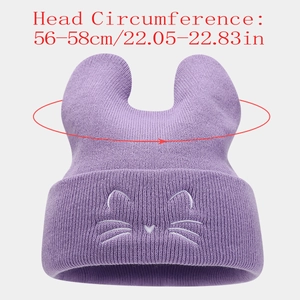 Detail showing cute cat ear embroidery and knitted texture on a purple winter beanie hat